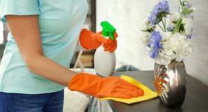 Woman with orange gloves bond cleaning in fraser coast